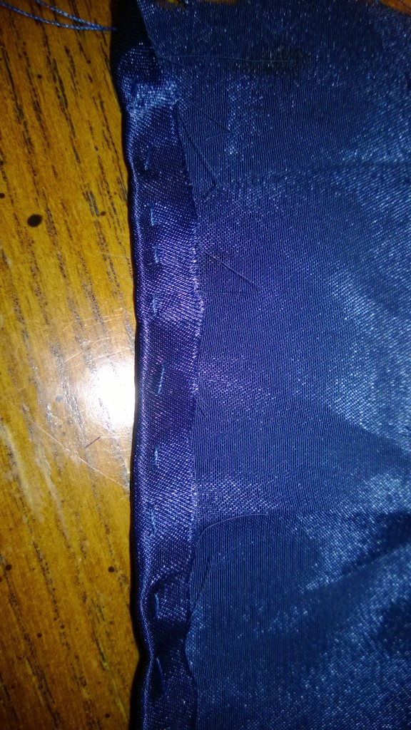 A single line of hand stitching holds a fold in place for easier hemming