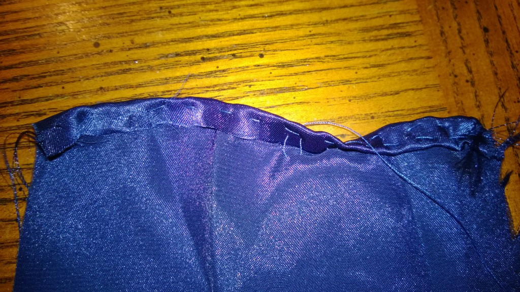 A partially hemmed edge. One part is only single-stitched- the other part is hemmed all the way.