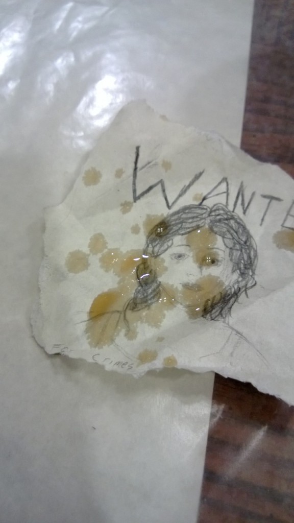 A splashed "wanted poster" of parchment paper.