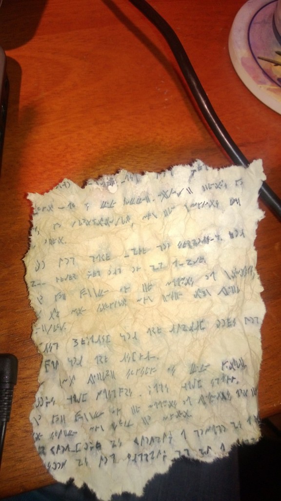 An old-looking piece of parchment with a weird alphabet on it.