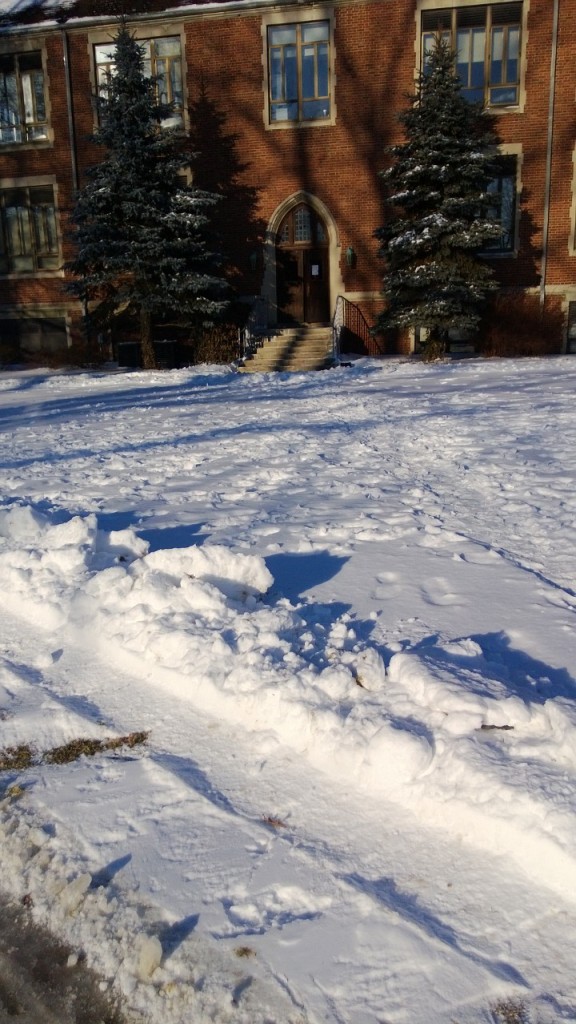 Blue looking snow with a red-brick building